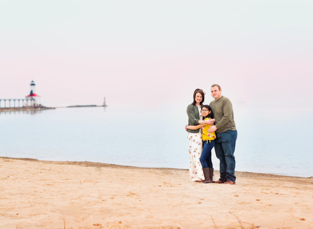 A family standing together on the beach at Washington Park, Michigan City - family photo by Leslie Q Photography