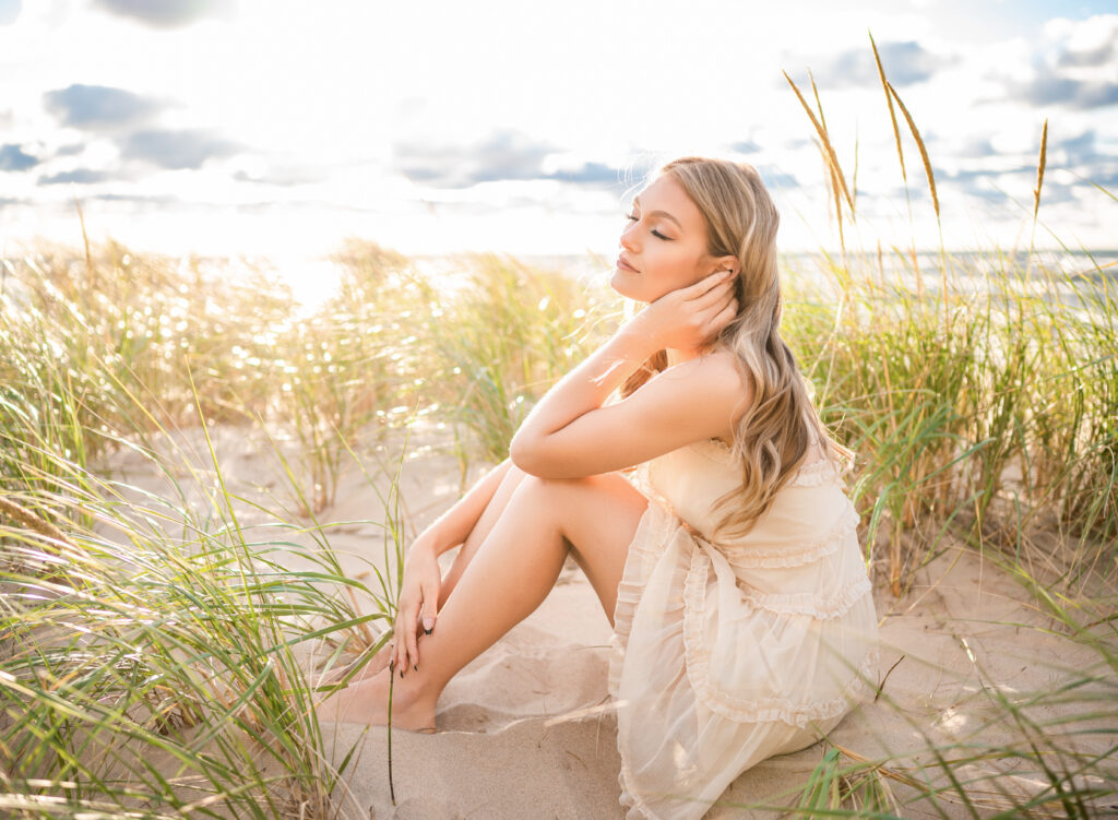 Woman in a light dress sitting in beach grass at Weko Beach, Bridgman, Michigan